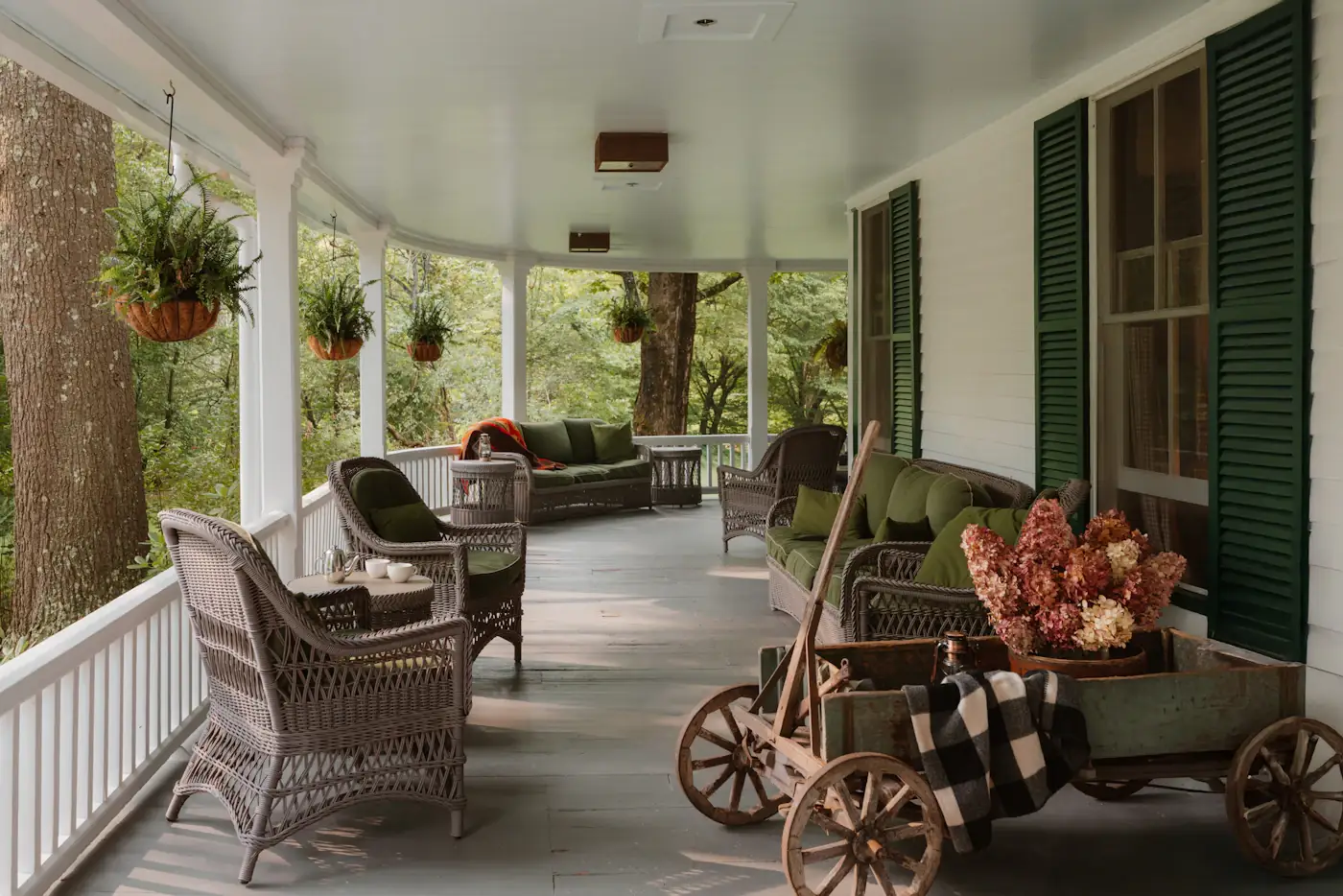 A shaded porch with wicker chairs